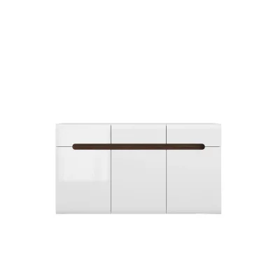 Шкаф AZTECA TRIO е елегантна бяла мебел за дневната или трапезарията. Разполага с три чекмеджета и три вратички с рафтове. Шкафът е част от серията мебели Azteca на полската марка BRW.Модулна система Azteca Trio е изработена в цвят бял гланц